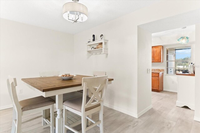 dining area featuring a chandelier and light wood-type flooring