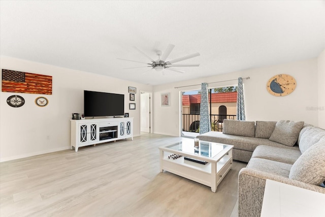 living room with ceiling fan and light hardwood / wood-style flooring