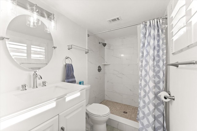 bathroom featuring vanity, a shower with shower curtain, and toilet