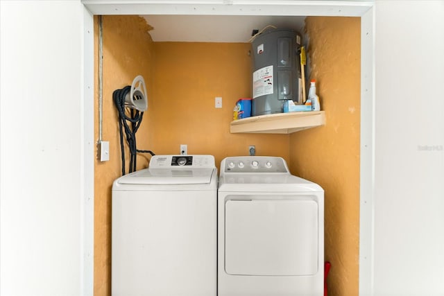 laundry area featuring water heater, electric dryer hookup, and separate washer and dryer