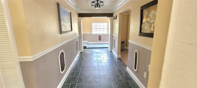 hallway featuring a textured ceiling and dark tile floors