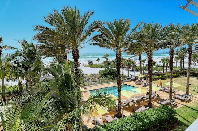 view of pool with a patio area and a water view