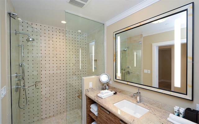 bathroom featuring crown molding, vanity, and a shower with shower door