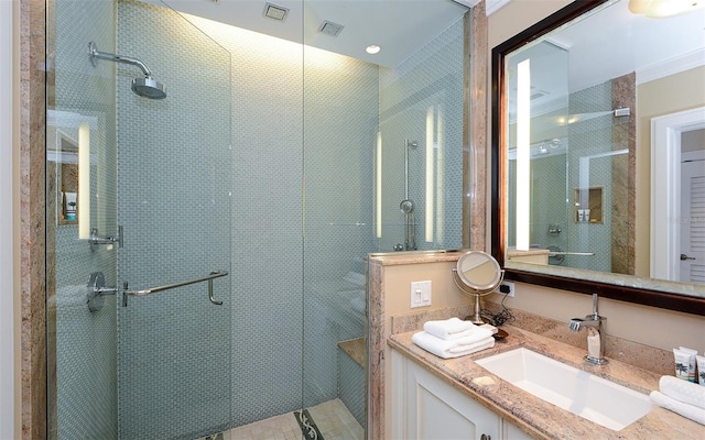 bathroom featuring vanity and a shower with door