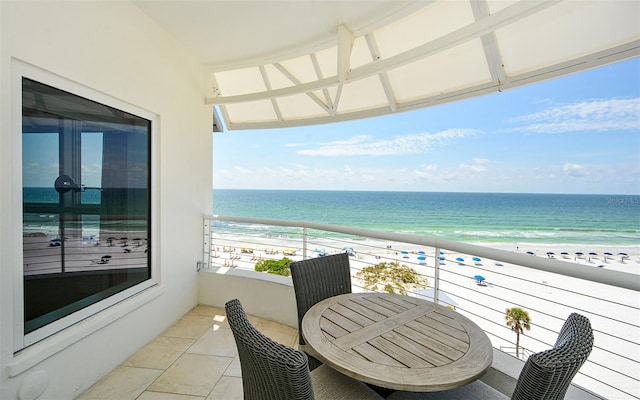 balcony featuring a beach view and a water view