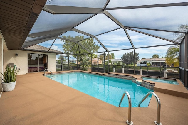 view of pool featuring glass enclosure, an in ground hot tub, and a patio