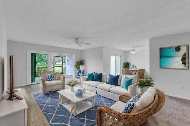 carpeted living room featuring ceiling fan and a textured ceiling