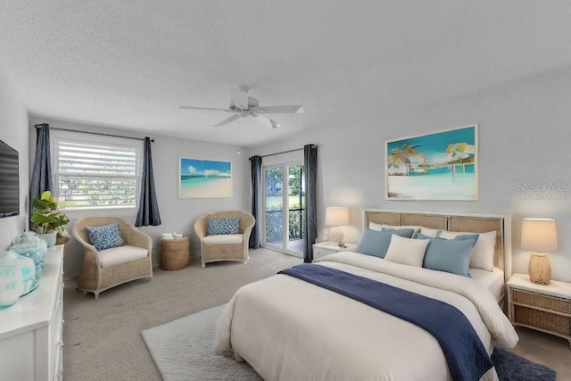 carpeted bedroom featuring a textured ceiling, access to outside, and ceiling fan