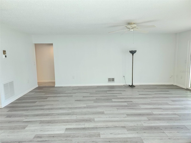 unfurnished room with ceiling fan, light hardwood / wood-style floors, and a textured ceiling