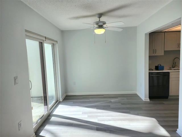 interior space featuring a textured ceiling, ceiling fan, sink, and light hardwood / wood-style flooring