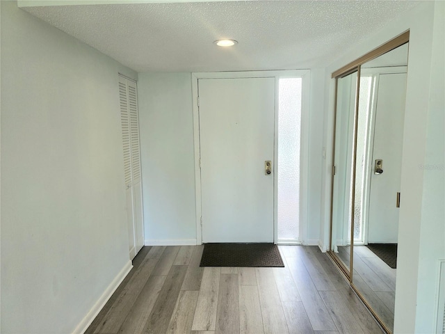 entryway featuring a textured ceiling and hardwood / wood-style flooring