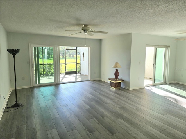 unfurnished living room with ceiling fan, a textured ceiling, and light wood-type flooring