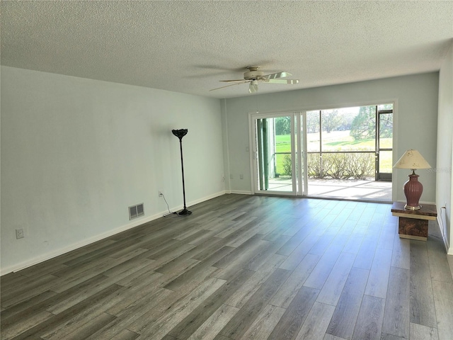 unfurnished living room featuring a textured ceiling, ceiling fan, and dark wood-type flooring