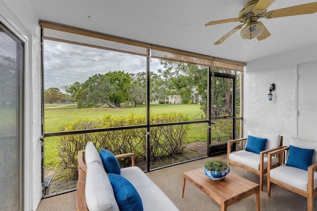 sunroom featuring ceiling fan