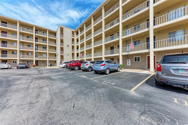 view of property featuring uncovered parking