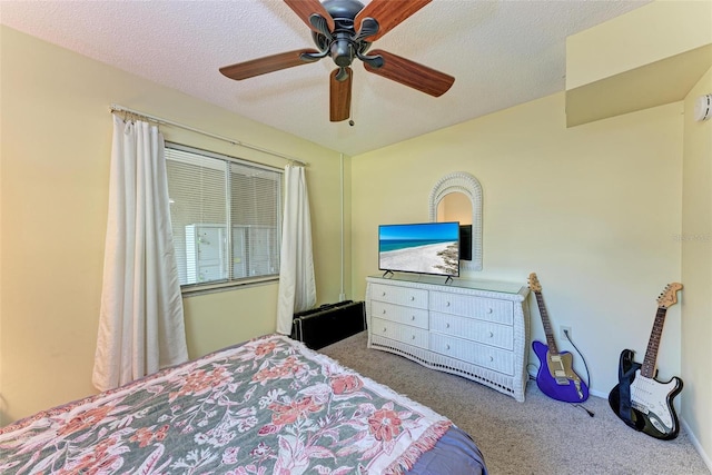 carpeted bedroom with a textured ceiling and ceiling fan