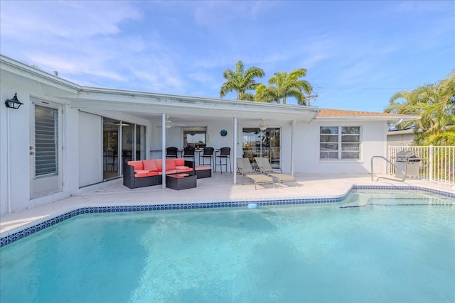 view of pool with outdoor lounge area, a patio, and ceiling fan