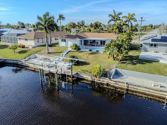 view of dock featuring a lawn and a water view