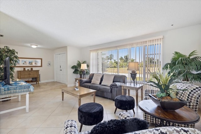 living room with a textured ceiling and light tile floors