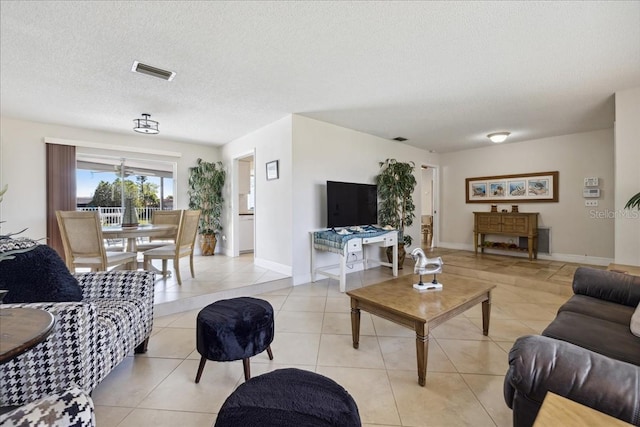 tiled living room with a textured ceiling