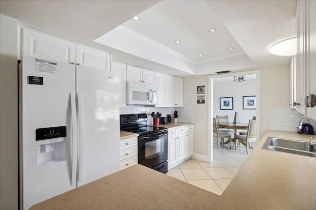 kitchen featuring white cabinetry, white appliances, light tile floors, a raised ceiling, and tasteful backsplash