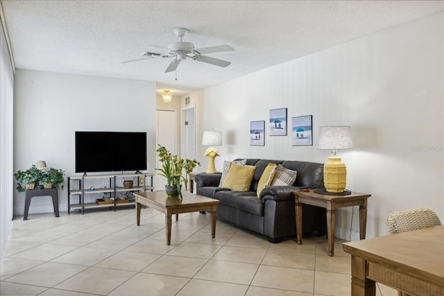 tiled living room featuring a textured ceiling and ceiling fan