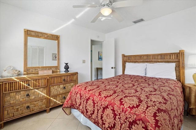 tiled bedroom featuring ceiling fan