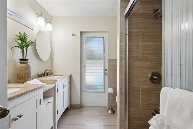 bathroom with a shower with door, tile flooring, and dual vanity