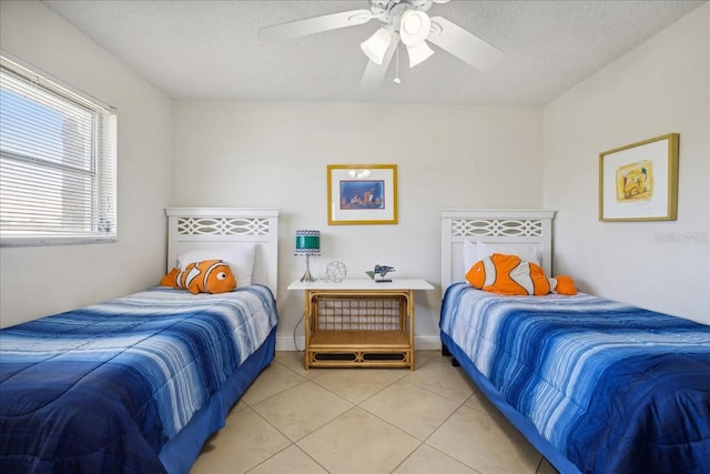 bedroom featuring light tile floors, a textured ceiling, and ceiling fan