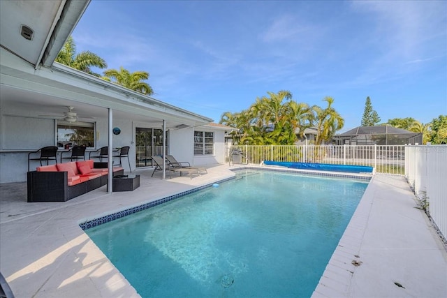 view of pool featuring a patio area, an outdoor living space, and ceiling fan