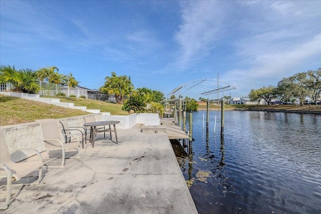 dock area featuring a water view and a lawn