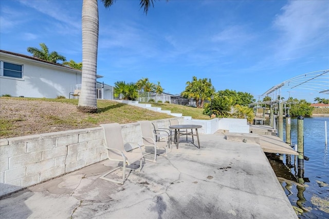 exterior space featuring a patio and a water view