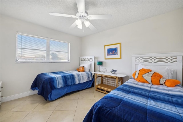 tiled bedroom featuring ceiling fan and a textured ceiling