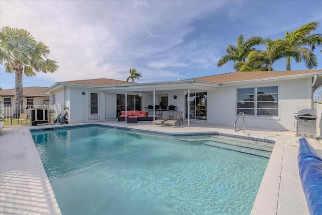 view of pool with a patio area, grilling area, and an outdoor hangout area