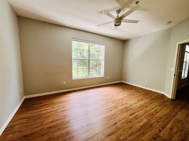 spare room with hardwood / wood-style flooring and ceiling fan