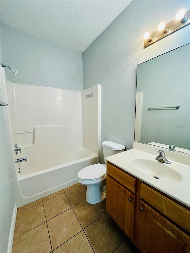 full bathroom with tile patterned flooring, washtub / shower combination, toilet, and vanity