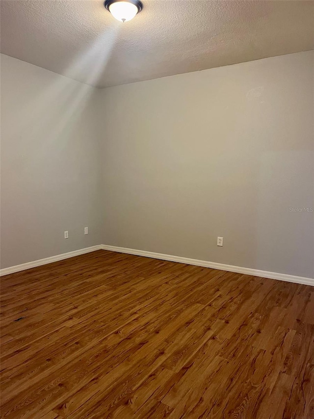 bonus room featuring a textured ceiling and wood-type flooring