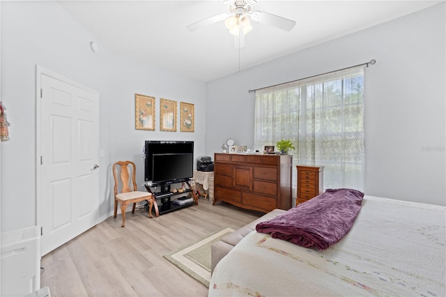 bedroom with ceiling fan and light hardwood / wood-style flooring