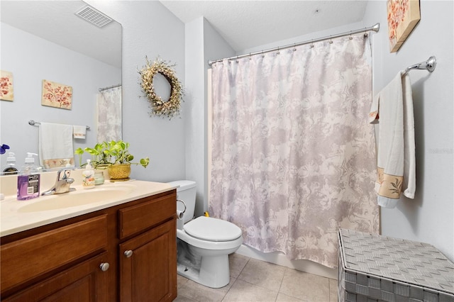 bathroom with toilet, a textured ceiling, vanity, and tile flooring