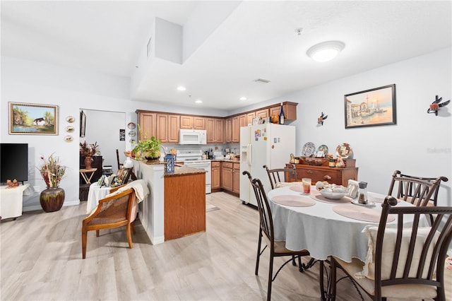 dining area with light hardwood / wood-style floors