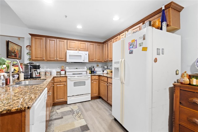 kitchen featuring light hardwood / wood-style floors, white appliances, sink, and light stone countertops