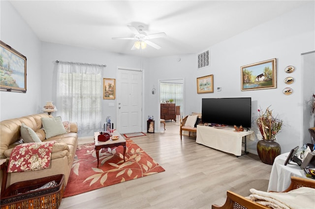 living room with ceiling fan and light hardwood / wood-style flooring