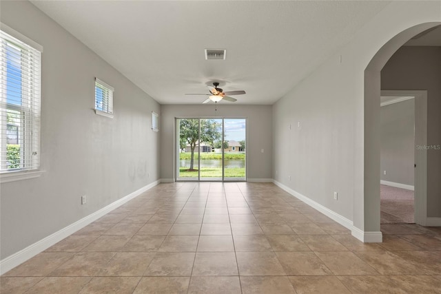 unfurnished room with ceiling fan and light tile patterned flooring