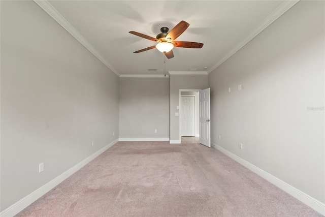 unfurnished room featuring ceiling fan, light colored carpet, and ornamental molding