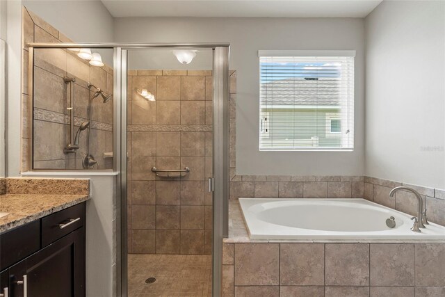 bathroom featuring vanity and plus walk in shower