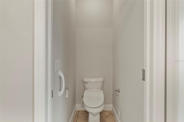 bathroom with tile patterned flooring and toilet