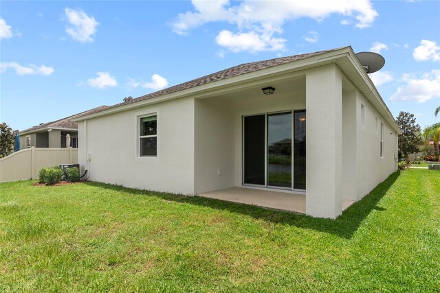 rear view of property with a patio area and a yard