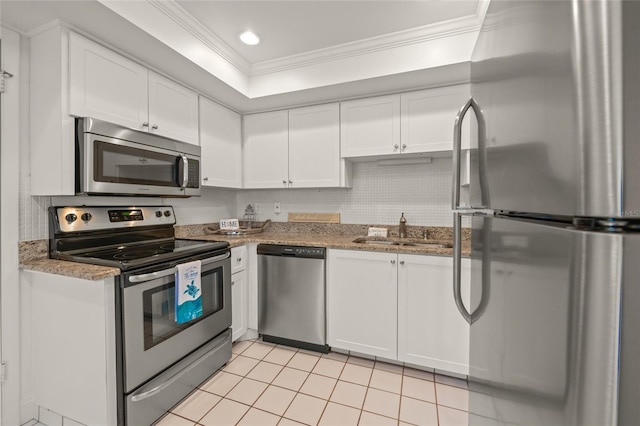 kitchen featuring sink, light tile patterned floors, crown molding, appliances with stainless steel finishes, and white cabinets