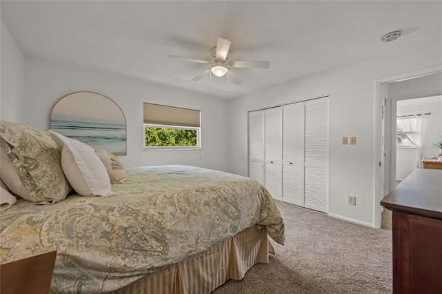 carpeted bedroom with ceiling fan and a closet