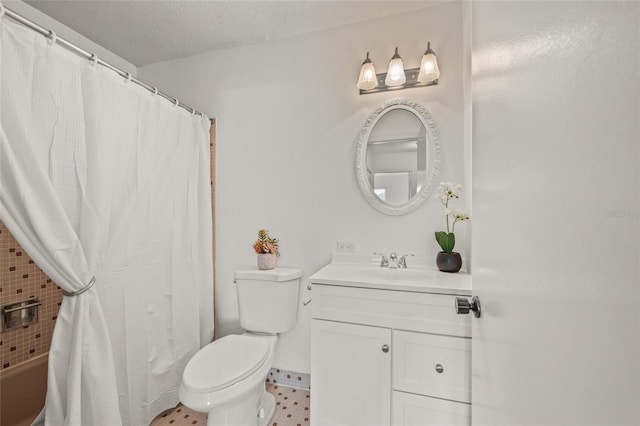 bathroom featuring a textured ceiling, toilet, and vanity